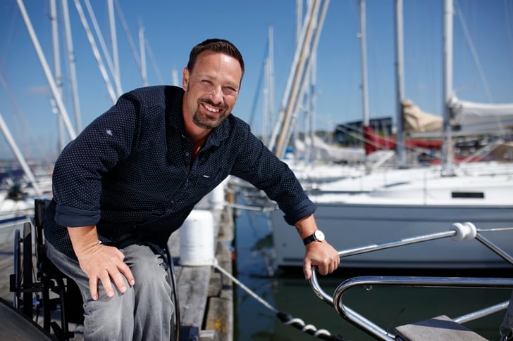 Man in wheelchair boarding a boat